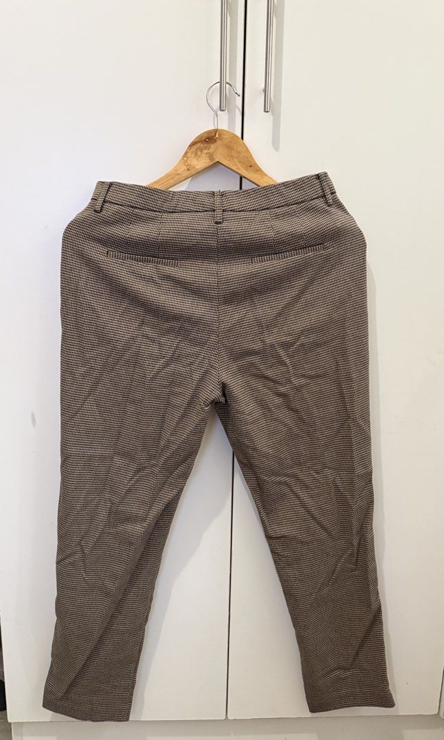 Mango Office Pants in Brown (Category: Other Bottoms) located in Pasig City. Submitted by riveraflows3 (Listing ID 1469218573, Image 2). Description: Size: EUR 38 / USA 6 / MEX 5 Pattern: Classic brown houndstooth Details: Structured waistband, zip fly with button closure, functional side pockets, and clean back pockets Fit: Tailored cut Condition: Well-used RFS: Decluttering.