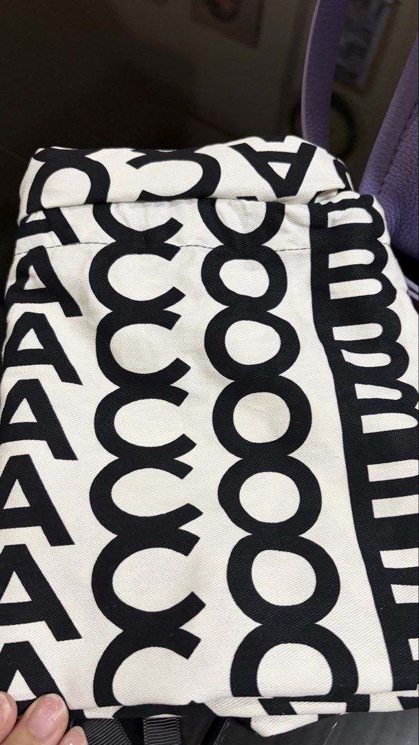 Marc Jacobs The Leather Small Tote Bag Lavender (Category: Luxury Bags & Wallets) located in Quezon City. Submitted by bella_ciao (Listing ID 1469231035, Image 2). Description: - Authentic Marc Jacobs leather tote in lavender purple - Crafted from durable pebbled leather with iconic bold text on the front - Secure zip-top closure with fabric-lined interior and handy pocket - Includes a detachable shoulder strap for crossbody or hand carry - Comes