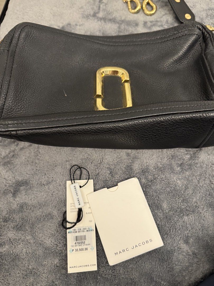 Marc Jacobs The Softshot 27 Black (Category: Luxury Bags & Wallets) located in Taguig. Submitted by sqaumejada (Listing ID 1469177493, Image 2). Description: - Brand: Marc Jacobs - Model: The Softshot 27 - Material: Soft pebble leather in classic black - Hardware: Elegant gold-tone - Compartments: Double zip design with interior card slots - Condition: Brand new with original tag attached - Inclusions: Brand card and dust pouch included.