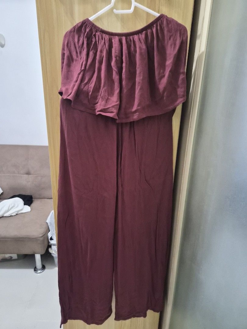 Maroon Off-Shoulder Ruffle Jumpsuit (Category: Jumpsuits) located in Mandaluyong City. Submitted by joyce1593 (Listing ID 1469254869, Image 3). Description: - Style: Off-shoulder jumpsuit with layered ruffle top - Bottoms: Flowy wide-leg pants - Fit: Comfortable elastic neckline and waistband for easy slip-on - Color: Solid wine red / maroon - Fabric: Soft and smooth material - Occasion: Versatile for casual days or night outs.