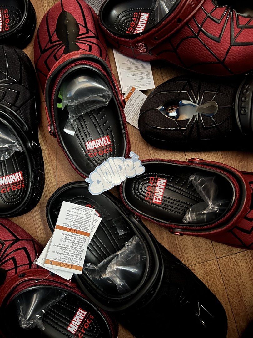 Marvel Spider-Man Crocs Clogs Black Red (Category: Slippers & Slides) located in Bulacan. Submitted by nelius.me (Listing ID 1469269401, Image 1). Description: - Brand new Spider-Man Marvel Crocs - Available colorways: Black and Red - Design: Spider web graphics on upper with shiny spider emblem - Interior: Official Marvel branding on the footbed - Condition: Brand new with original tags and packing inserts inside the toe box - Perfect for Marvel