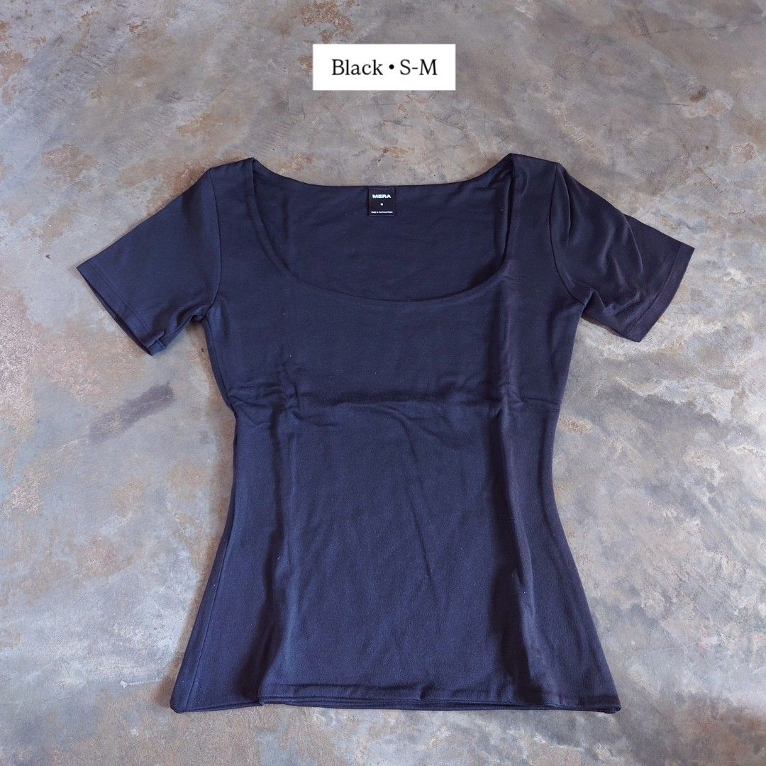 MERA Black Square Neck Short Sleeve Top S-M (Category: Shirts) located in Diffun. Submitted by declutteredbyJill (Listing ID 1469236437, Image 1). Description: - Brand: MERA - Color: Black - Size: Tagged M (fits S to M comfortably) - Material: Stretchy, comfortable cotton - Style: Short sleeves, wide scoop neckline, fitted cut - Condition: Brand new, unworn (tags removed) - Versatility: Essential basic piece that easily pairs with high-waisted je
