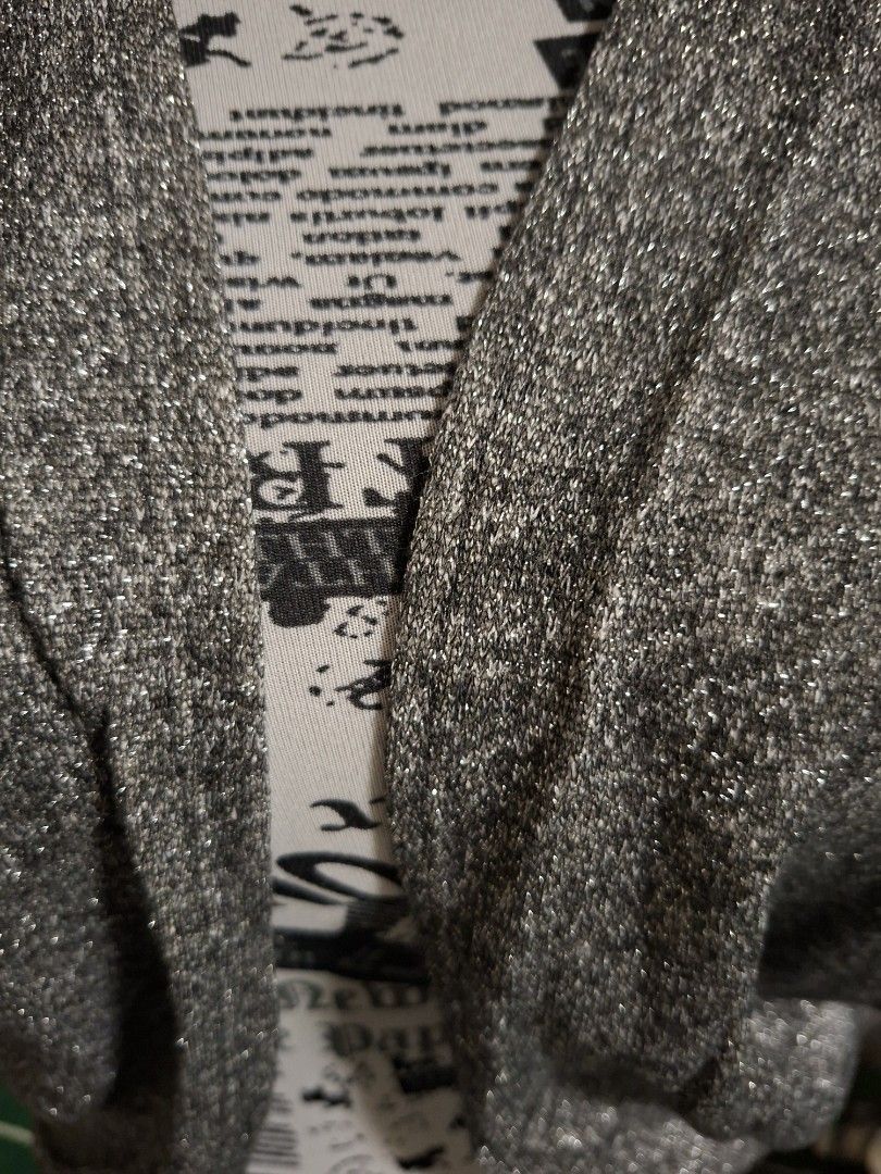 Metallic silver shrug cardigan bolero (Category: Coats, Jackets and Outerwear) located in Manila. Submitted by mialiurshop (Listing ID 1469226921, Image 3). Description: - Color: Sparkly silver with a shimmer knit finish - Design: Open front with short sleeves - Fit: Cropped length, hits right at the waist - Style: Great layering piece for evening wear and parties - Condition: Excellent.
