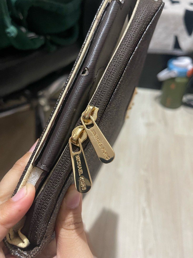 Michael Kors Brown MK Logo Tablet Case Organizer (Category: Accessory Holder, Box & Organizers) located in Baguio. Submitted by find_found001 (Listing ID 1469338936, Image 2). Description: - Authentic Michael Kors tablet case and organizer - Classic dark brown signature MK monogram print with gold-tone hardware - Dual zipper pulls stamped with the iconic brand logo - Front exterior features a chic gold metal nameplate - Light cream interior linin