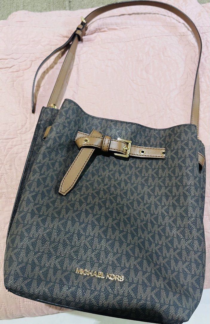 Michael Kors Brown Monogram Bucket Bag with Strap (Category: Shoulder Bags) located in Cagayan de Oro. Submitted by brex7 (Listing ID 1469215870, Image 1). Description: - Brand: Michael Kors - Style: Brown monogram bucket bag with tan leather trim - Hardware: Gold-tone accents - Strap: Adjustable shoulder strap - Closure: Top magnetic snap closure - Interior: Clean brown lining with convenient slip pockets - Exterior: Includes a handy back pocket