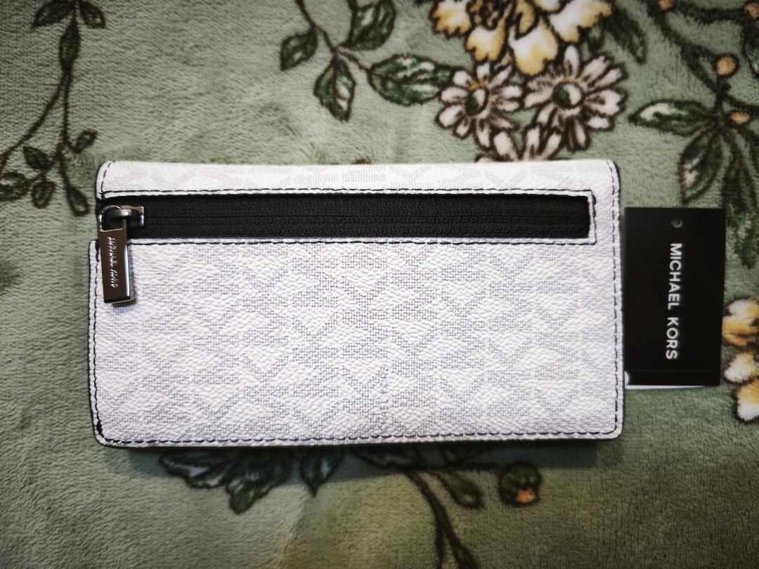 Michael Kors Cooper Slim Bifole Card Case Bright White (Category: Luxury Bags & Wallets) located in Baguio. Submitted by zia_zab (Listing ID 1469257213, Image 2). Description: - Brand: Michael Kors - Model: Cooper Folding Card Case - Color: Bright white monogram with black interior - Condition: Brand new with original tag attached, unworn - Features: Multiple card slots, secure snap button closure, and external zip pocket with branded zipper pull