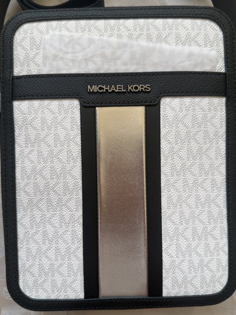 Michael Kors MEN Cooper Flight crossbody bag (Category: Sling Bags) located in San Pedro. Submitted by moonllax (Listing ID 1469237107, Image 3). Description: - Authentic Michael Kors crossbody bag - White and black signature logo canvas with black leather trim - Eye-catching metallic gold vertical center stripe - Silver-tone hardware and front metal logo lettering - Comfortable adjustable black canvas strap - Brand new with original tag attached