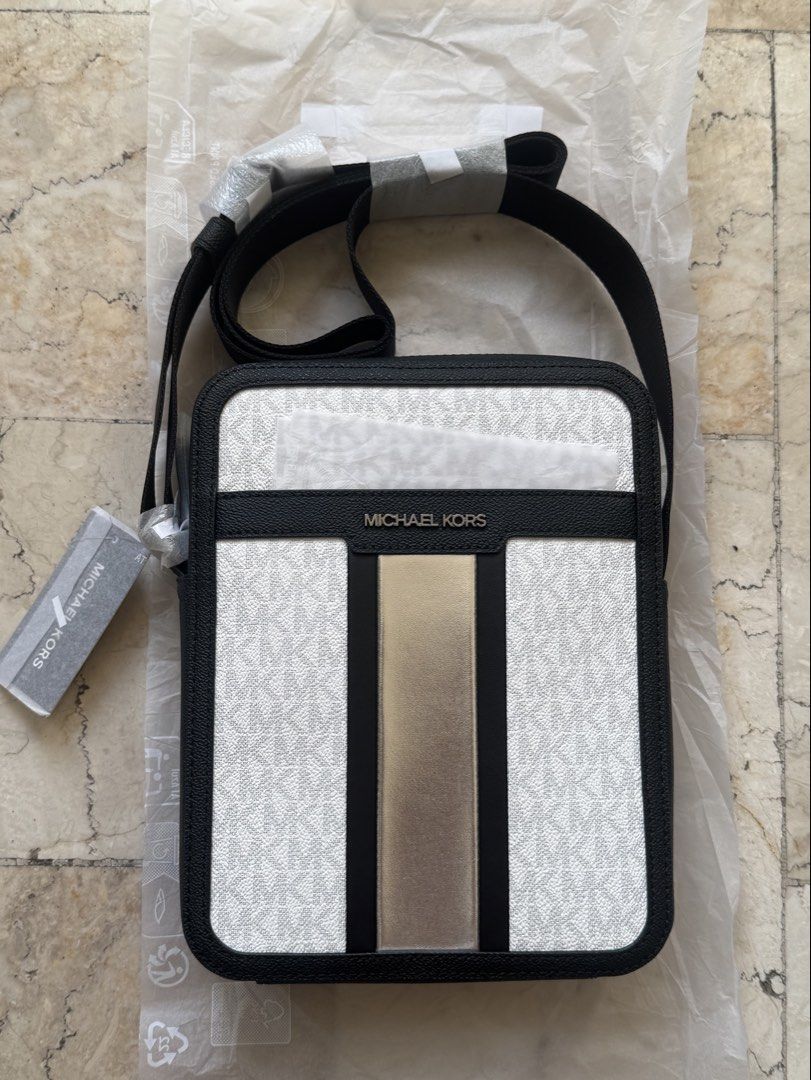 Michael Kors MEN Cooper Flight crossbody bag (Category: Sling Bags) located in San Pedro. Submitted by moonllax (Listing ID 1469237107, Image 1). Description: - Authentic Michael Kors crossbody bag - White and black signature logo canvas with black leather trim - Eye-catching metallic gold vertical center stripe - Silver-tone hardware and front metal logo lettering - Comfortable adjustable black canvas strap - Brand new with original tag attached