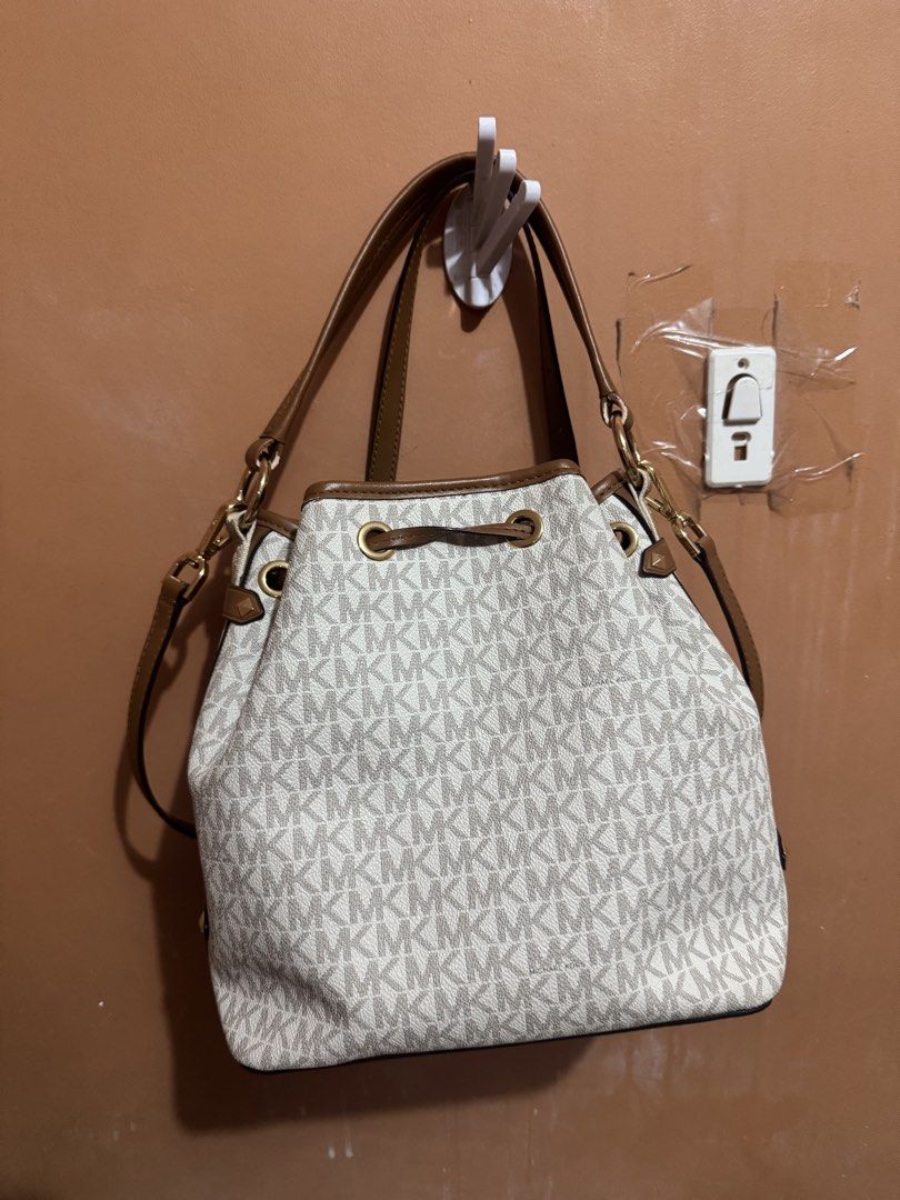 Michael Kors MK monogram canvas bucket bag brown white (Category: Luxury Bags & Wallets) located in Dasmarinas. Submitted by rinz0man (Listing ID 1469305043, Image 3). Description: - Authentic Michael Kors bucket bag in signature MK monogram canvas with stylish white and brown panels - Elegant gold-tone hardware and front slip pocket with metal logo lettering - Secure drawstring top closure with a spacious interior for your daily essentials - Inc