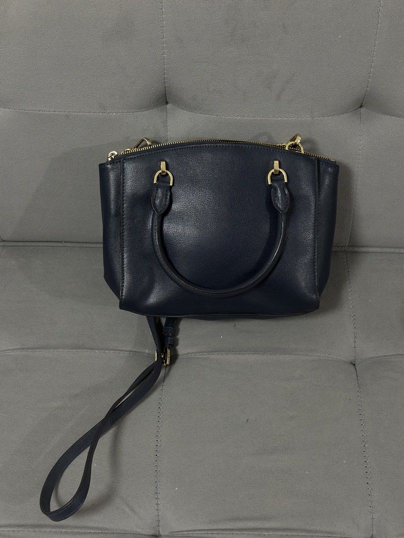 Michael Kors Navy Blue Studded Handbag (Category: Luxury Bags & Wallets) located in Tarlac. Submitted by via_banana (Listing ID 1469198394, Image 2). Description: - Brand: Michael Kors - Color: Navy blue with premium gold hardware - Design: Chic front studded details and a stylish chain link accent on one side - Carry Options: Double top handles and a convenient detachable shoulder strap - Closure: Secure top zipper closure - Interior: Clean fabr