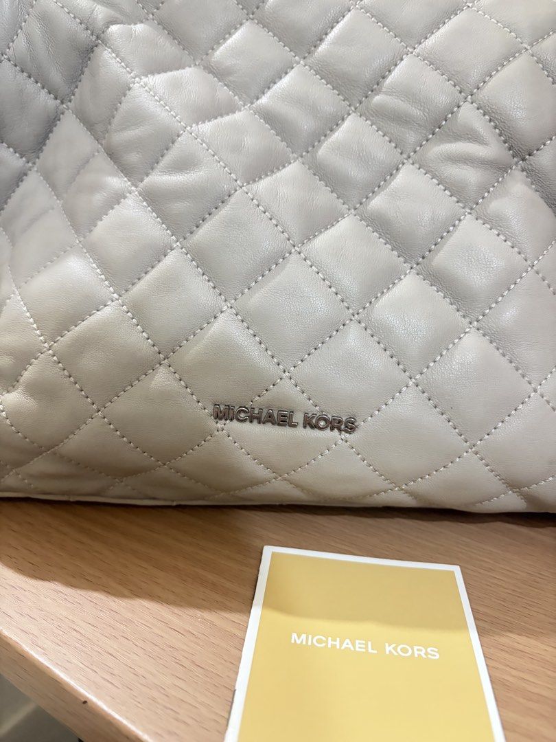 Michael Kors Rachel Quilted Shoulder Bag (Category: Shoulder Bags) located in Iloilo. Submitted by miafinds (Listing ID 1469278001, Image 3). Description: - Brand: Michael Kors - Model: Rachel Quilted Shoulder Bag - Color: Light Grey with silver-tone hardware - Material: Premium leather - Features: Zip-top closure, chain strap details, front logo lettering - Interior: Signature monogram fabric lining with slip and zip pockets - Inclusions: Offici