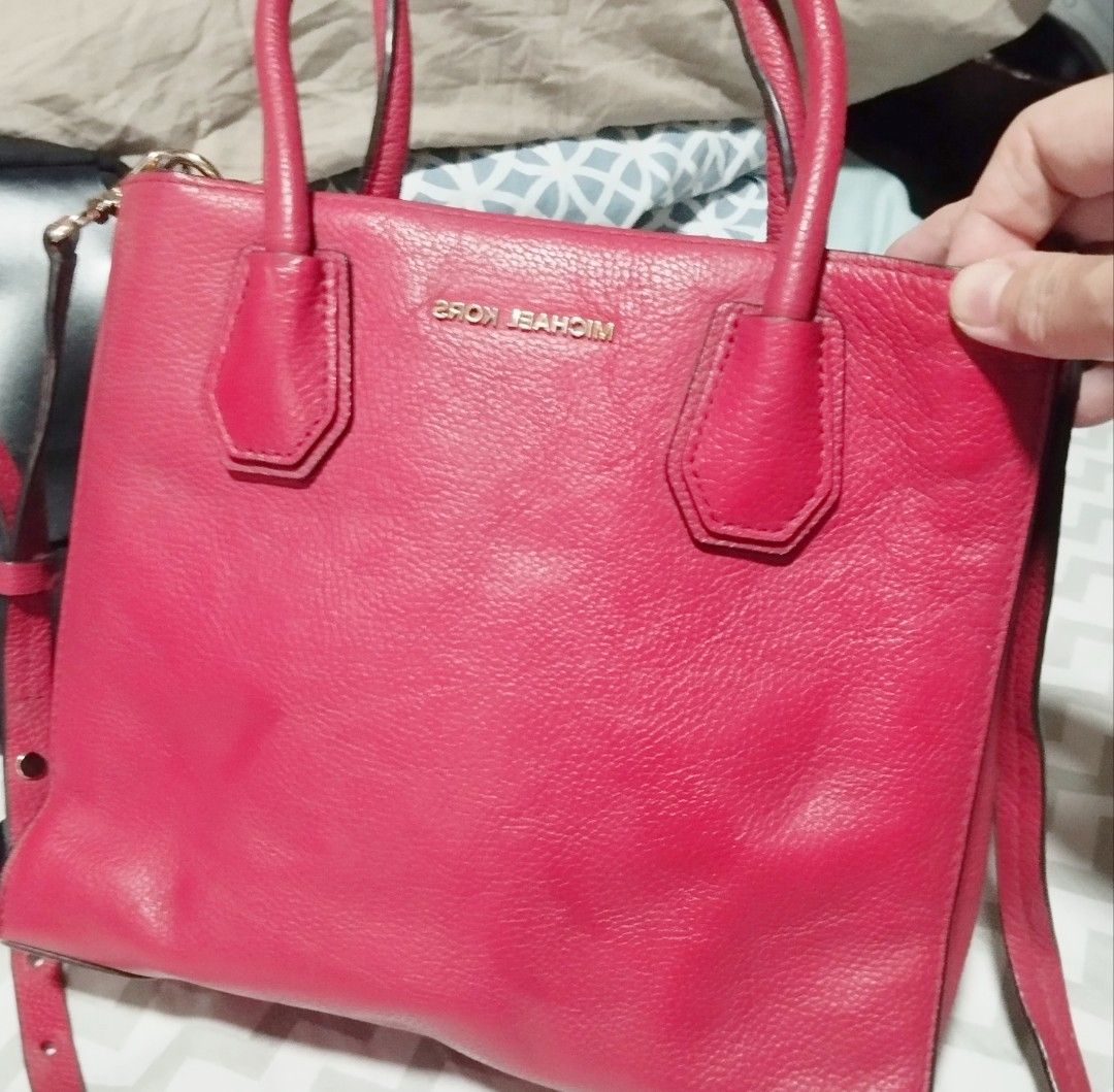 Michael Kors Red Leather Tote Handbag (Category: Tote Bags) located in Manila. Submitted by lene48 (Listing ID 1469165214, Image 2). Description: - Brand: Michael Kors - Material: Premium pebbled leather in bright red - Hardware: Elegant gold-tone accents and protective feet - Carry options: Double top handles and adjustable shoulder strap - Closure: Secure zip top with a structured silhouette - Condition: Clean interior and exterior, ready for d