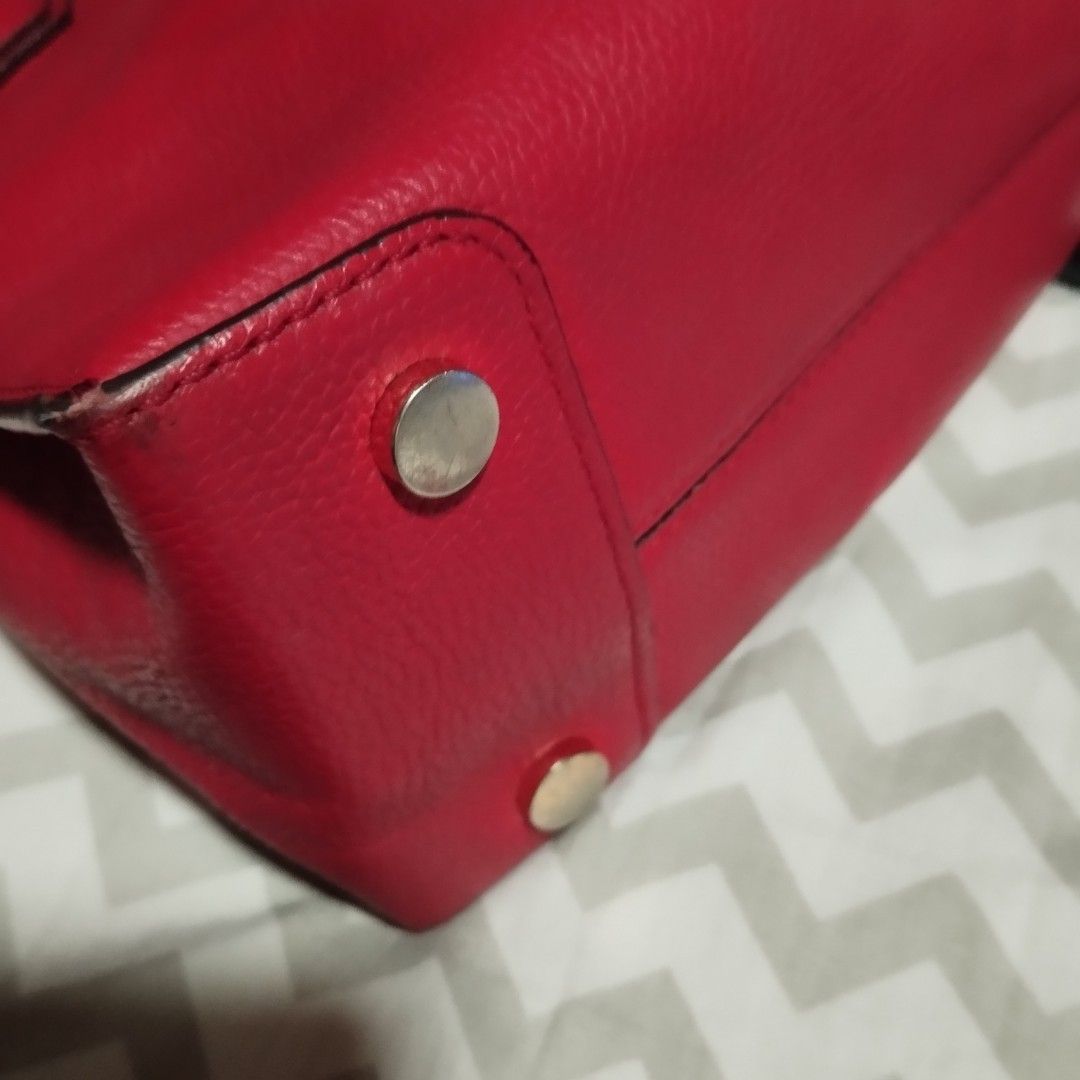Michael Kors Red Leather Tote Bag (Category: Tote Bags) located in Manila. Submitted by lene48 (Listing ID 1469239982, Image 3). Description: - Brand: Michael Kors - Color: Bright Red - Material: Genuine pebbled leather - Hardware: Gold-toned stamping and accents - Closure: Secure zip-top closure - Interior: Fabric-lined with a convenient zip pocket - Protection: Bottom feet to protect the base - Condition: Excellent, well-maintained - Mode of Pa