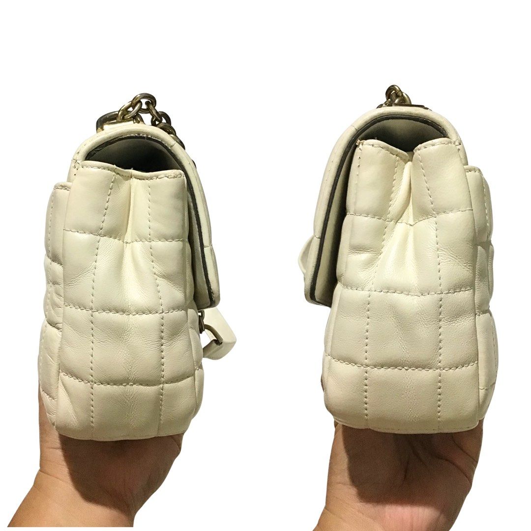 Michael Kors Soho Quilted Shoulder Bag - Off-white (Category: Luxury Bags & Wallets) located in Sorsogon. Submitted by sprucemuse (Listing ID 1469332066, Image 3). Description: Brand: Michael Kors Color: Off-white Type: Shoulder and Crossbody Bag Size: 20cm x 5cm x 14cm (Medium) Material: Genuine leather (outer), Textile (inner) Hardware: Gold Features: 1 snap lock outer back pocket, 1 zippered inner middle pocket, 1 zippered inner pocket, 1 open