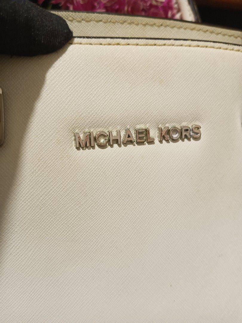 Michael Kors White Saffiano Leather Handbag (Category: Luxury Bags & Wallets) located in Digos. Submitted by chihanu (Listing ID 1469200002, Image 2). Description: - Brand: Michael Kors - Material: Durable Saffiano leather in classic white - Hardware: Silver-tone with metal logo lettering - Handles/Strap: Dual top handles and a long adjustable shoulder strap - Closure: Secure zip-top closure - Interior: Spacious compartment for all your daily ess
