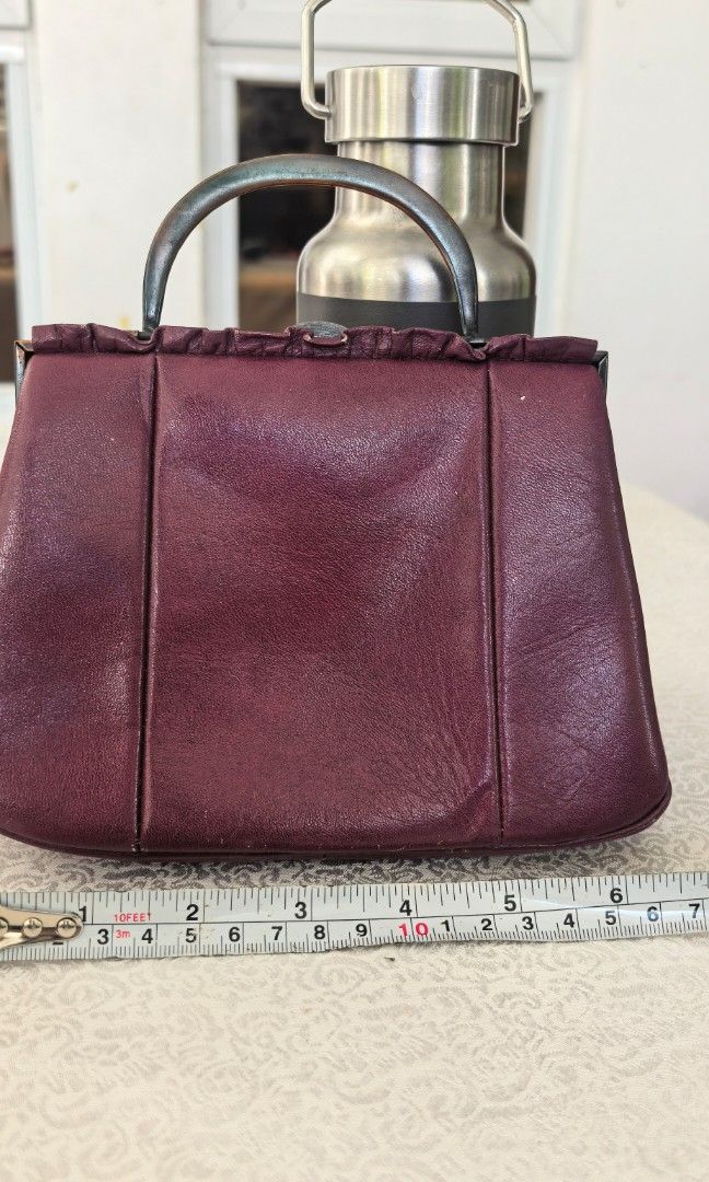 Micro kiss lock handbag (Category: Purses & Pouches) located in Tuguegarao City. Submitted by zenphoenix-7ad615 (Listing ID 1469189273, Image 2). Description: Dark purple leather micro Kisslock bag Length 7 inches CP does not fit.