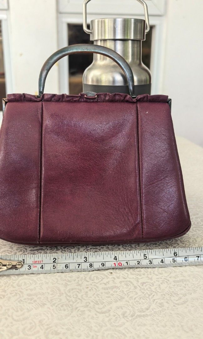 Micro kiss lock handbag (Category: Purses & Pouches) located in Tuguegarao City. Submitted by zenphoenix-7ad615 (Listing ID 1469189273, Image 1). Description: Dark purple leather micro Kisslock bag Length 7 inches CP does not fit.