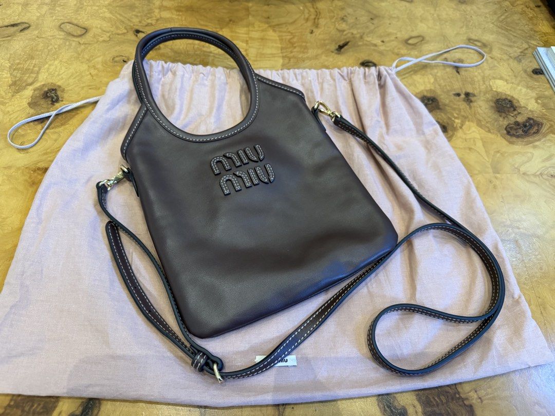 Miu Miu Dark Brown Leather Bag (Category: Luxury Bags & Wallets) located in Manila. Submitted by moscloset (Listing ID 1469231616, Image 3). Description: BRAND NEW AUTHENTIC MIU MIU MINI IVY TOTE BAG Current Market Price: ₱100,000 Condition: Excellent (10/10) Reason for Selling: Never used Additional Details: Color: Chocolate Brown Flaws: None Inclusions: Dust bag, crossbody strap.