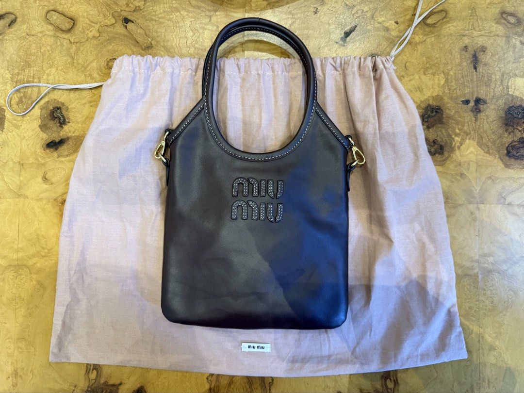 Miu Miu Dark Brown Leather Bag (Category: Luxury Bags & Wallets) located in Manila. Submitted by moscloset (Listing ID 1469231616, Image 1). Description: BRAND NEW AUTHENTIC MIU MIU MINI IVY TOTE BAG Current Market Price: ₱100,000 Condition: Excellent (10/10) Reason for Selling: Never used Additional Details: Color: Chocolate Brown Flaws: None Inclusions: Dust bag, crossbody strap.