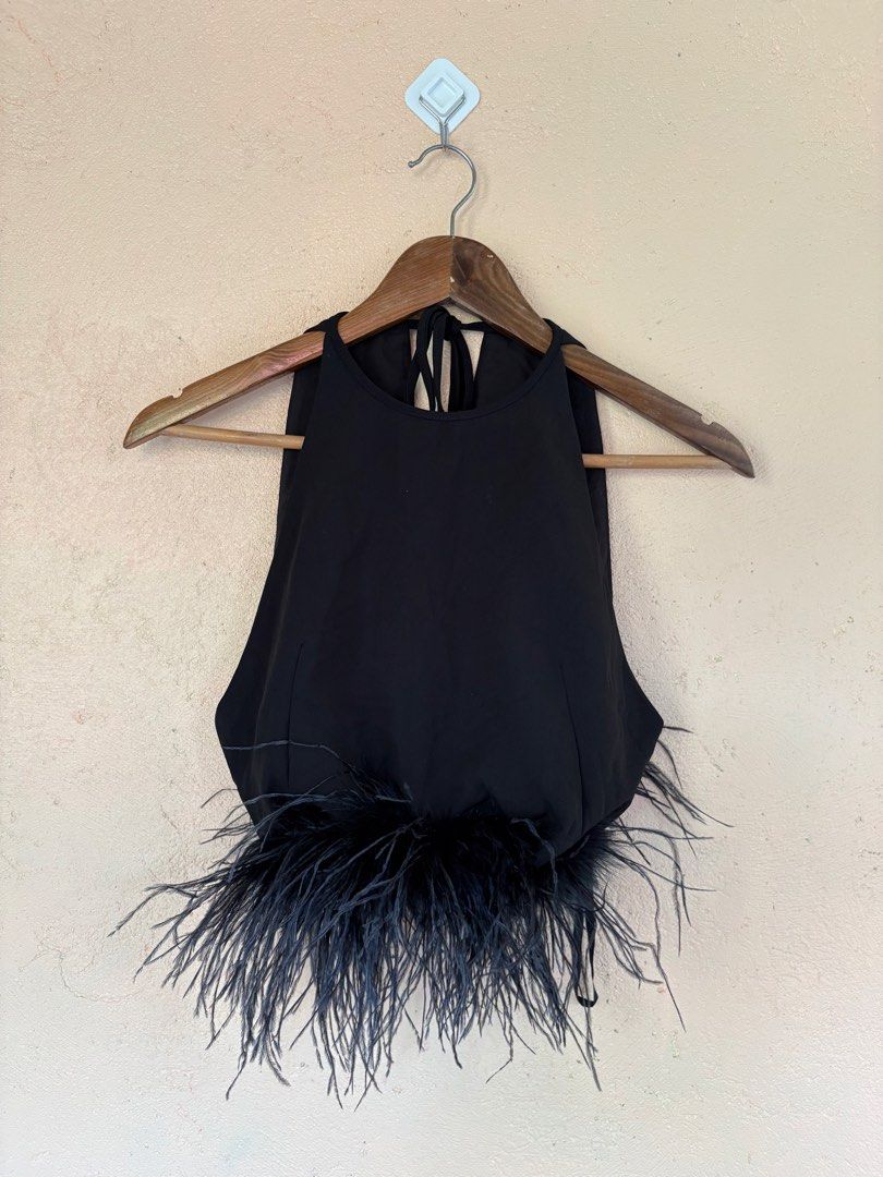 Miu Miu Stretch Cady Halter Top with Feathers (Category: Sleeveless) located in Pozorrubio. Submitted by zionegotthrift (Listing ID 1469199230, Image 1). Description: - Brand: Miu Miu - Style: Stretch cady halter top with tie closure - Color: Black - Size: 38 (PH S/M) - Material: Virgin wool and elastane - Special Detail: Genuine ostrich feather trim along the hem - Inclusions: Original designer label and composition tags attached.