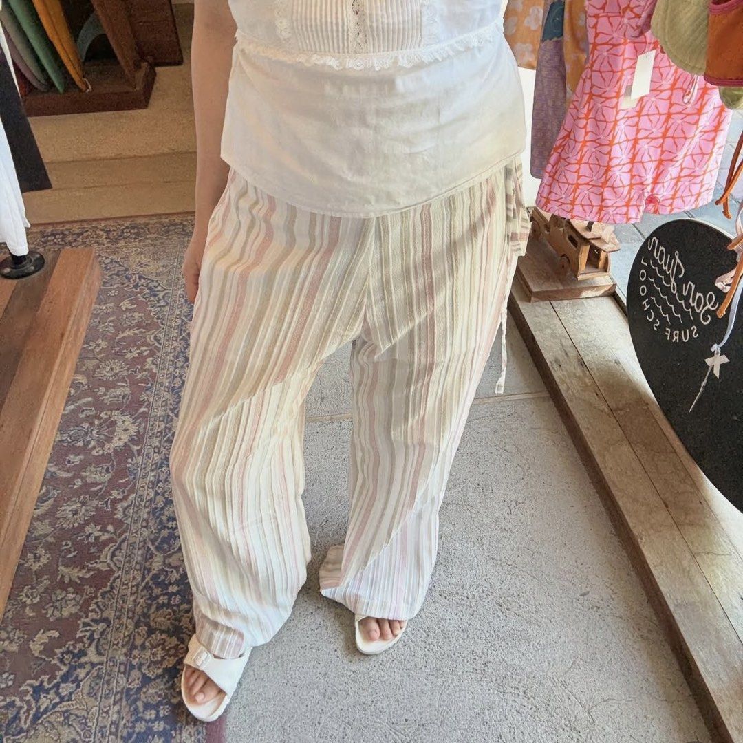 Miu The Label Cairo Pants (Category: Jeans) located in Quezon City. Submitted by ky.sveug (Listing ID 1469316779, Image 2). Description: RFS: impulse buy - removed tag - Trendy striped wide-leg pants in white, pink, and taupe - Lightweight and flowy fabric for all-day comfort - Relaxed fit with a full-length style - Adjustable elastic waistband with cute side tie strings - Easy to style with basic tops for a chic casual look.