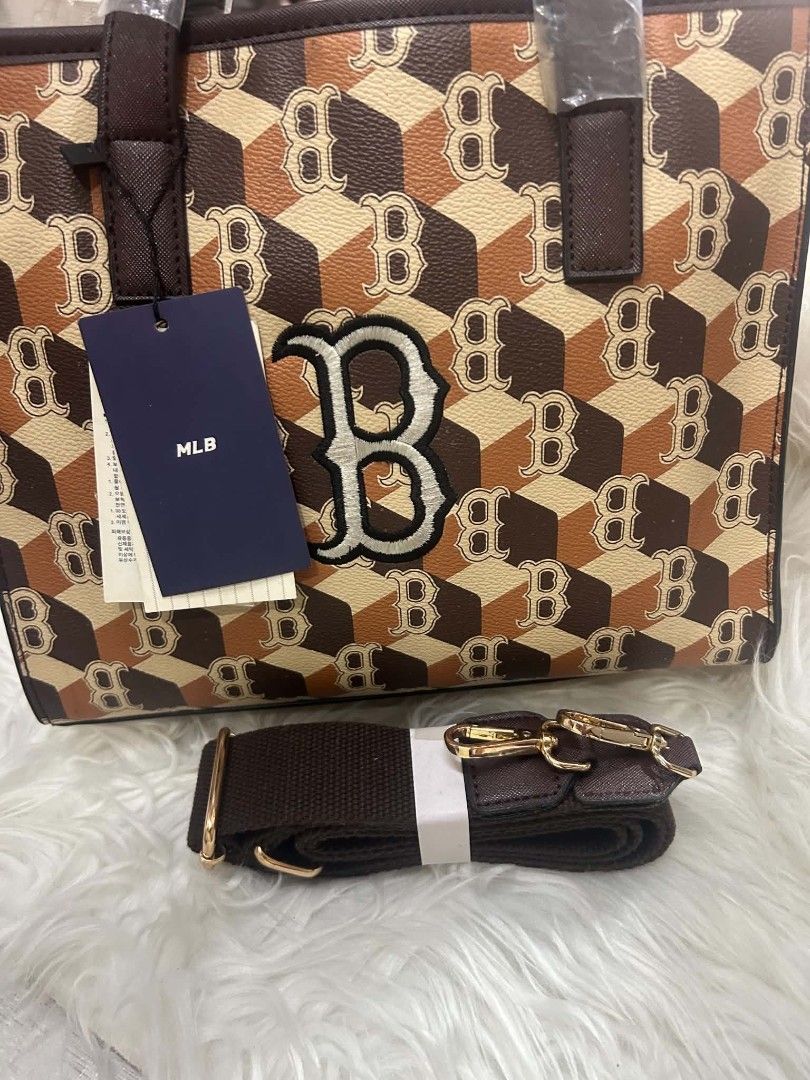 MLB Brown Monogram Tote Bag with Strap (Category: Tote Bags) located in Manila. Submitted by kkiato (Listing ID 1469283568, Image 1). Description: - Stylish brown and beige MLB monogram cube print tote bag - Dual top handles wrapped in protective plastic for safekeeping - Includes a detachable matching shoulder strap for versatile wear - Main interior compartment equipped with a secure zipper side pocket - Clean interior lining with original bran