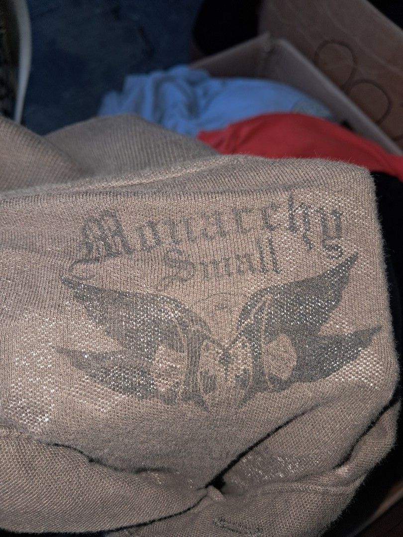Monarchy Graphic Polo Shirt Grey Y2K Style (Category: Tshirts & Polo Shirts ) located in Mandaluyong City. Submitted by kusineronghustla (Listing ID 1469244835, Image 3). Description: - Brand: Monarchy - Color: Grey with slight vintage wash - Design: Bold gothic lettering and intricate graphic prints on chest and back - Details: Polo collar with button placket, short sleeves, standard fit - Vibe: Early 2000s streetwear - Note: Please check photos