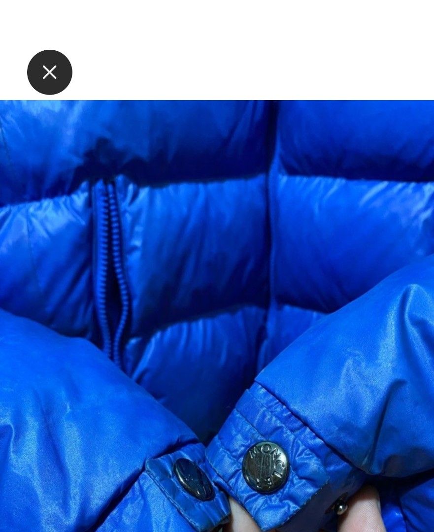 Moncler Blue Down Puffer Jacket Size L (Category: Coats, Jackets and Outerwear) located in Makati City. Submitted by bastybb (Listing ID 1469207416, Image 3). Description: DECLUTTERING! Selling for 800 only! (negotiable) - Brand: Moncler - Color: Vibrant royal blue with a glossy finish - Size: L (tag attached at collar) - Features: Detachable hood with snap buttons, branded zipper pull and hardware - Detail: Classic felt Moncler logo patch on the