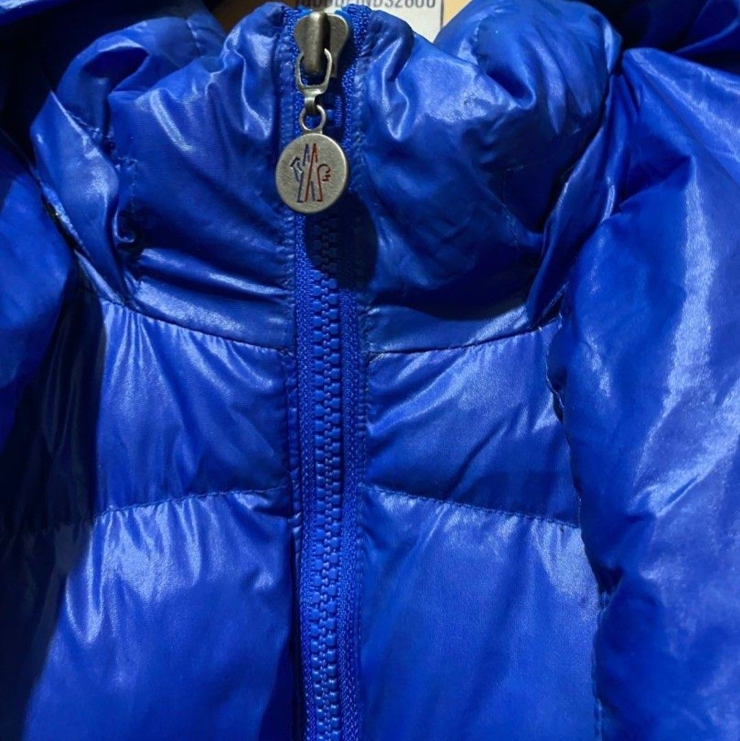 Moncler Blue Down Puffer Jacket Size L (Category: Coats, Jackets and Outerwear) located in Makati City. Submitted by bastybb (Listing ID 1469207416, Image 2). Description: DECLUTTERING! Selling for 800 only! (negotiable) - Brand: Moncler - Color: Vibrant royal blue with a glossy finish - Size: L (tag attached at collar) - Features: Detachable hood with snap buttons, branded zipper pull and hardware - Detail: Classic felt Moncler logo patch on the