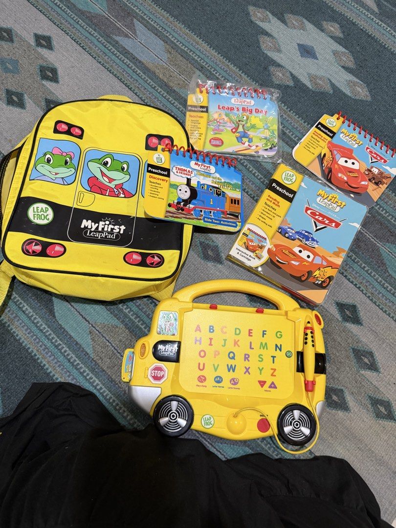 My First LeapPad Learning System with Backpack and Books (Category: Educational & Learning Toys) located in Paranaque City. Submitted by bperez (Listing ID 1469349190, Image 2). Description: - Complete My First LeapPad interactive learning system in a bright yellow bus design - Includes matching yellow backpack carrying case for easy storage and travel - Attached magic pen stylus for interactive play - Comes with 4 books: Thomas and the School Tr