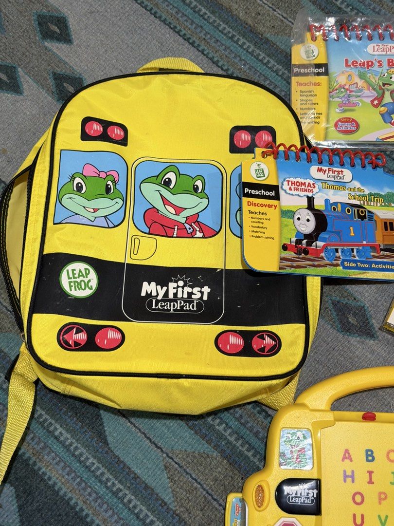 My First LeapPad Learning System with Backpack and Books (Category: Educational & Learning Toys) located in Paranaque City. Submitted by bperez (Listing ID 1469349190, Image 1). Description: - Complete My First LeapPad interactive learning system in a bright yellow bus design - Includes matching yellow backpack carrying case for easy storage and travel - Attached magic pen stylus for interactive play - Comes with 4 books: Thomas and the School Tr