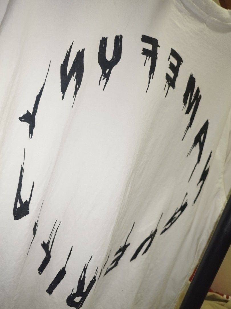 Name Funy Guerrilla Graphic Tee Size XL (Category: Tshirts & Polo Shirts ) located in Tuguegarao City. Submitted by ZeevLim (Listing ID 1469326994, Image 3). Description: - Brand: Name Funy Guerrilla - Size: XL - Color: Clean White - Design: Bold photographic face print with distressed typography on front, large stylized circular lettering on back - Details: Crew neck, short sleeves - Condition: good condition have minimal stains.