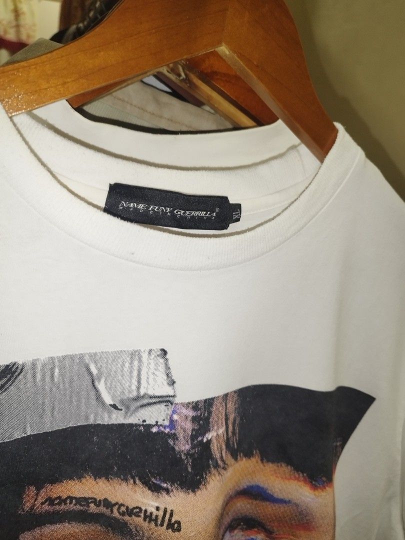 Name Funy Guerrilla Graphic Tee Size XL (Category: Tshirts & Polo Shirts ) located in Tuguegarao City. Submitted by ZeevLim (Listing ID 1469326994, Image 2). Description: - Brand: Name Funy Guerrilla - Size: XL - Color: Clean White - Design: Bold photographic face print with distressed typography on front, large stylized circular lettering on back - Details: Crew neck, short sleeves - Condition: good condition have minimal stains.