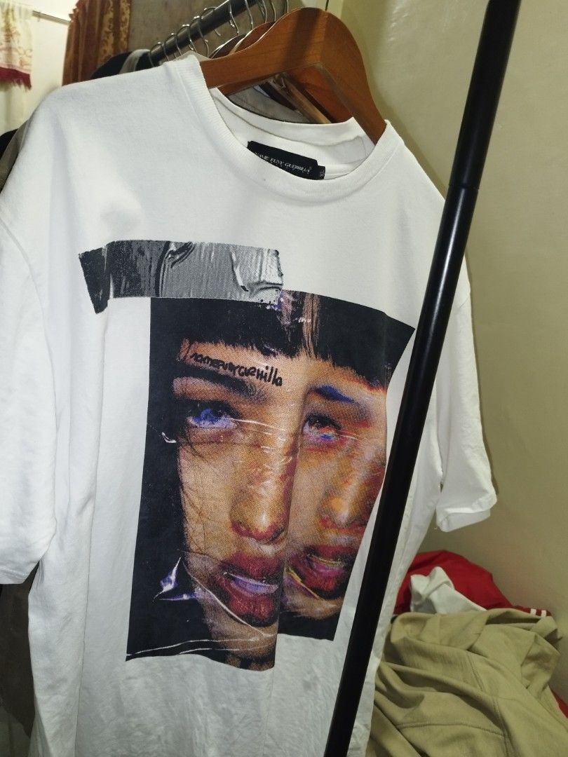 Name Funy Guerrilla Graphic Tee Size XL (Category: Tshirts & Polo Shirts ) located in Tuguegarao City. Submitted by ZeevLim (Listing ID 1469326994, Image 1). Description: - Brand: Name Funy Guerrilla - Size: XL - Color: Clean White - Design: Bold photographic face print with distressed typography on front, large stylized circular lettering on back - Details: Crew neck, short sleeves - Condition: good condition have minimal stains.