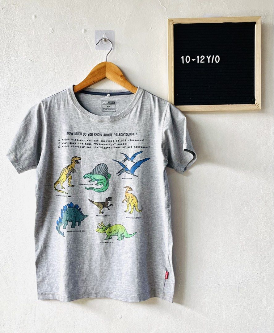 Name It Dinosaur Paleontology Kids (Category: Babies & Kids Fashion) located in Caloocan City. Submitted by lovemyclothes21 (Listing ID 1469267630, Image 1). Description: - Size: 11-12 Years (146-152) - Design: Cool dinosaur graphics with fun paleontology trivia - Material: Super soft and comfortable cotton - Condition: Clean, clear print, and ready to wear - Color: Classic grey with short sleeves and round neckline.