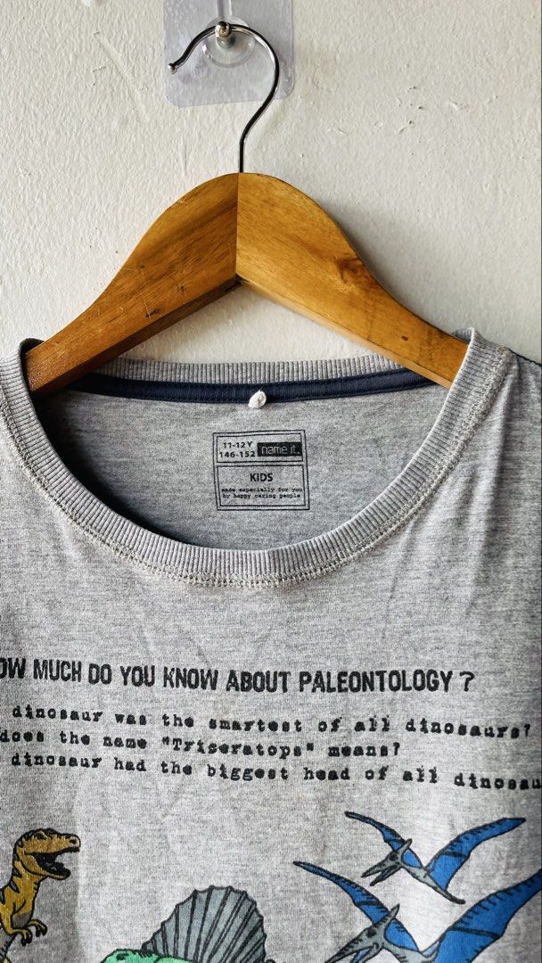 Name It Dinosaur Paleontology Kids (Category: Babies & Kids Fashion) located in Caloocan City. Submitted by lovemyclothes21 (Listing ID 1469267630, Image 3). Description: - Size: 11-12 Years (146-152) - Design: Cool dinosaur graphics with fun paleontology trivia - Material: Super soft and comfortable cotton - Condition: Clean, clear print, and ready to wear - Color: Classic grey with short sleeves and round neckline.
