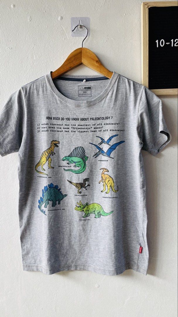 Name It Dinosaur Paleontology Kids (Category: Babies & Kids Fashion) located in Caloocan City. Submitted by lovemyclothes21 (Listing ID 1469267630, Image 2). Description: - Size: 11-12 Years (146-152) - Design: Cool dinosaur graphics with fun paleontology trivia - Material: Super soft and comfortable cotton - Condition: Clean, clear print, and ready to wear - Color: Classic grey with short sleeves and round neckline.