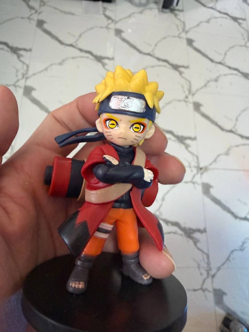 Naruto figure -12 pcs (Category: Figurines & Statues) located in Caloocan City. Submitted by silentdragon_931b8a (Listing ID 1469223588, Image 3). Description: - Character: Kakuzu from Naruto (Akatsuki) - Design: Wearing iconic red cloud cloak with floating facial masks behind him - Pose: Dynamic stance with one hand reaching forward - Base: Sturdy black circular base included - Condition: Great, clean paintwork with no scuffs - Ideal for: Anime 