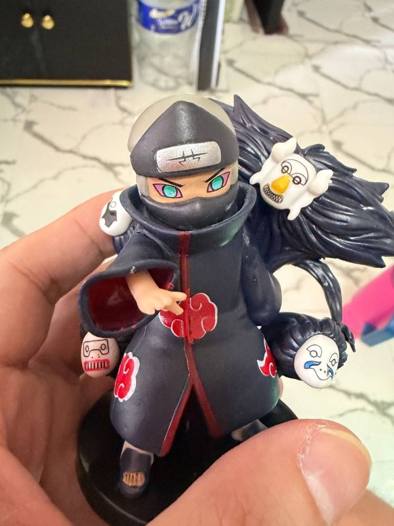 Naruto figure -12 pcs (Category: Figurines & Statues) located in Caloocan City. Submitted by silentdragon_931b8a (Listing ID 1469223588, Image 2). Description: - Character: Kakuzu from Naruto (Akatsuki) - Design: Wearing iconic red cloud cloak with floating facial masks behind him - Pose: Dynamic stance with one hand reaching forward - Base: Sturdy black circular base included - Condition: Great, clean paintwork with no scuffs - Ideal for: Anime 