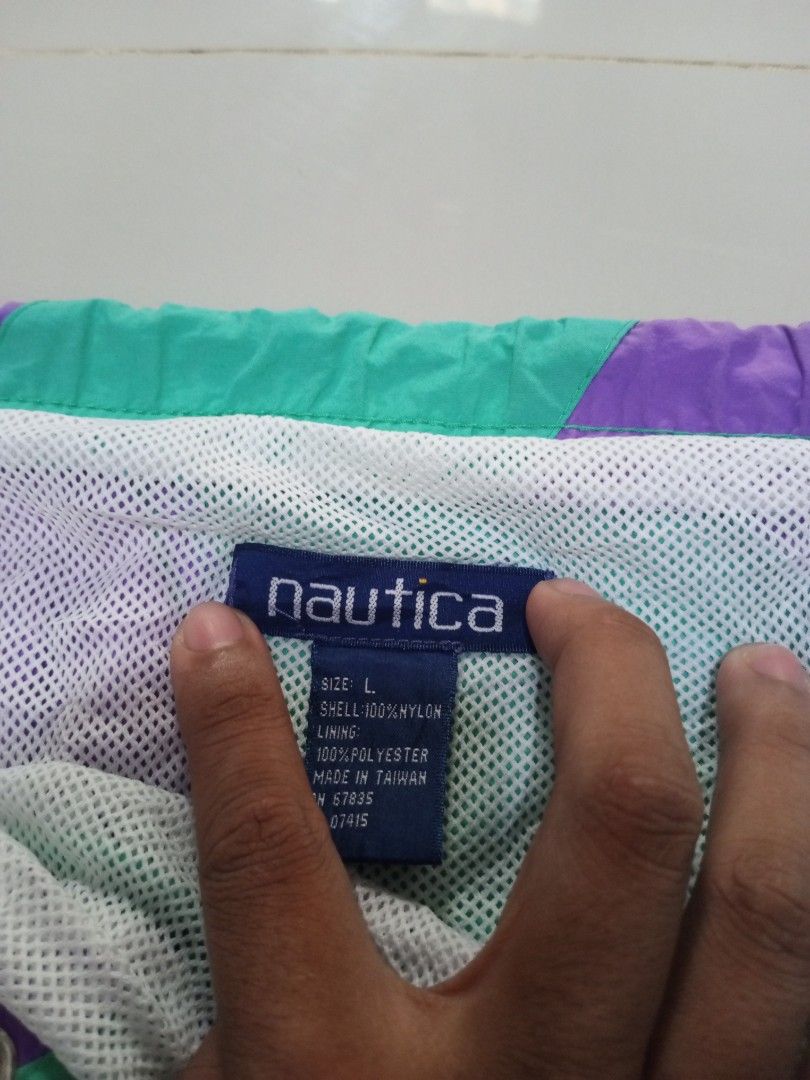 Nautica Swim Short Size Large Over Size (Category: Swim Trunks & Board Shorts) located in Magdalena. Submitted by magdalenathrift20 (Listing ID 1469168357, Image 3). Description: - Brand: Nautica - Design: Purple and turquoise striped pattern - Size: L (Oversized fit) - Waistline: Stretches from 46 to 50 inches - Length: 19 inches - Material: 100% nylon shell with 100% polyester mesh lining - Features: Side pockets, adjustable drawstring waistban