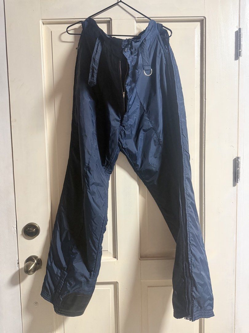 Navy Blue Winter Snow Pants with Zippers (Category: Jeans) located in Tagum. Submitted by hachiiing (Listing ID 1469392885, Image 1). Description: - Color: Dark blue - Material: Thick nylon (windproof and moisture-resistant) - Closure: Front zipper with integrated belt loops and metal D-ring - Convenience: Full-length side zippers for easy ventilation and boot access - Durability: Reinforced black scuff guards on lower cuffs LARGE TO XL SIZE GOOD
