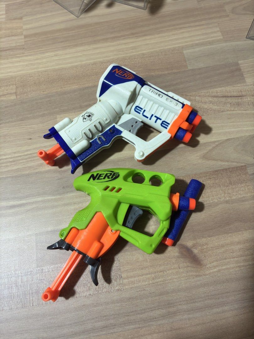 Nerf Elite Triad EX-3 and Green Dart Blaster (Category: Action & Battle Toys) located in Mandaluyong City. Submitted by littlecatstore (Listing ID 1469392811, Image 2). Description: - Set of 2 working Nerf blasters ready for action - Includes white/blue Elite Triad EX-3 and neon green blaster with dart storage - Both tested and fully functional - Perfect for backyard target practice or indoor battles - Great bundle value, grab it fast!.