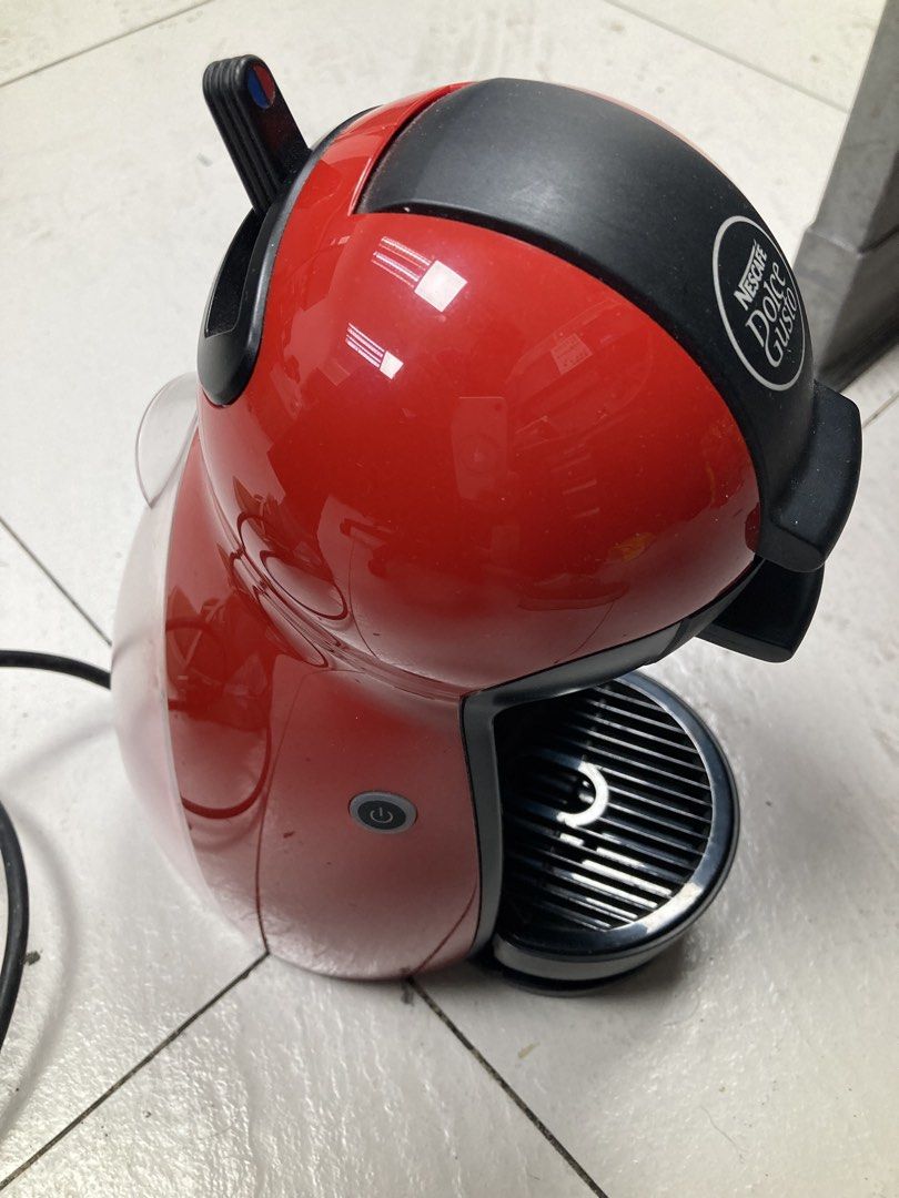 Nescafe Dolce Gusto Coffee Machine Red (Category: Coffee Machines & Makers) located in Makati City. Submitted by kaboochie (Listing ID 1469340376, Image 3). Description: - Red and black Nescafe Dolce Gusto capsule coffee machine - Compact size ideal for small kitchens or office desks - Convenient water tank located at the back - Manual top lever for easy hot or cold beverage selection - Accessible power button on the side - Standard power cord an