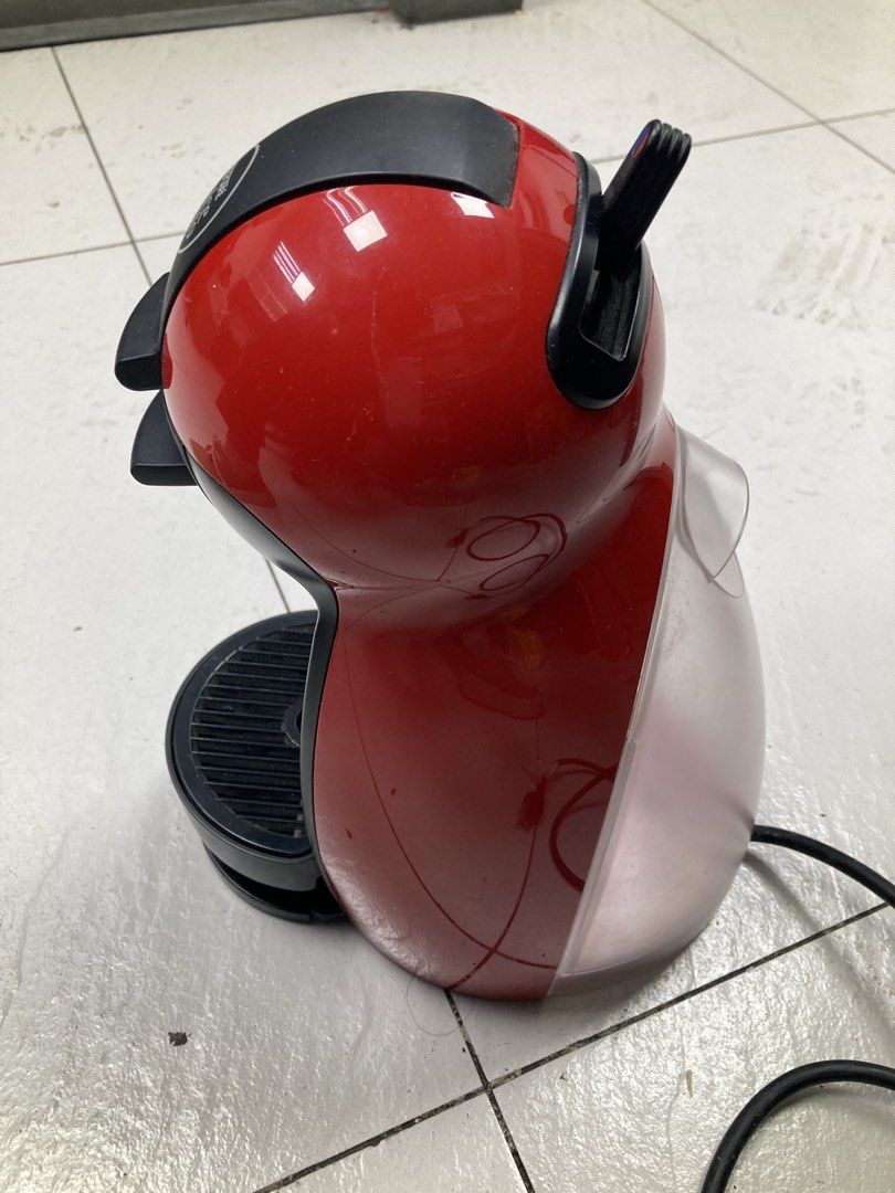 Nescafe Dolce Gusto Coffee Machine Red (Category: Coffee Machines & Makers) located in Makati City. Submitted by kaboochie (Listing ID 1469340376, Image 1). Description: - Red and black Nescafe Dolce Gusto capsule coffee machine - Compact size ideal for small kitchens or office desks - Convenient water tank located at the back - Manual top lever for easy hot or cold beverage selection - Accessible power button on the side - Standard power cord an