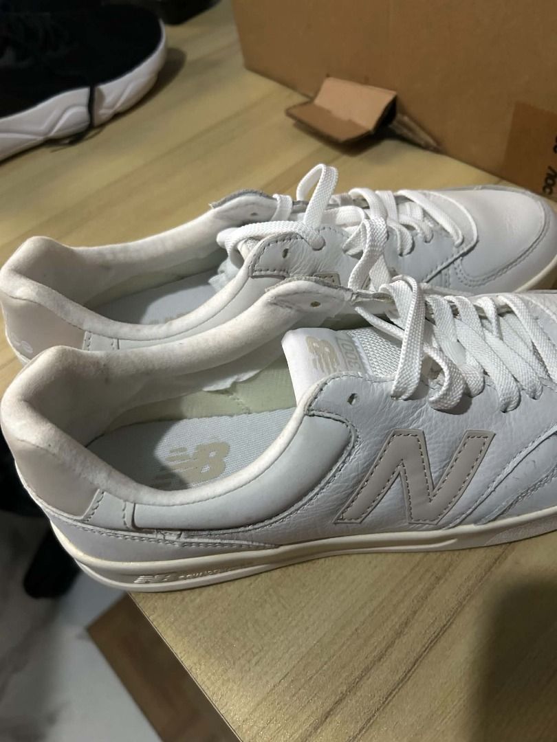 New Balance 300 White Sneakers (Category: Sneakers) located in Manila. Submitted by rachelandkokoy (Listing ID 1469230345, Image 2). Description: - Brand: New Balance - Model: 300 Court Sneakers - Color: White leather with grey logo accents - Style: Low-top, everyday casual kicks - Features: Clean white laces, cushioned insoles, rubber outsoles - Condition: Light wear around the collar lining, overall well-maintained - Bought in the US but never 
