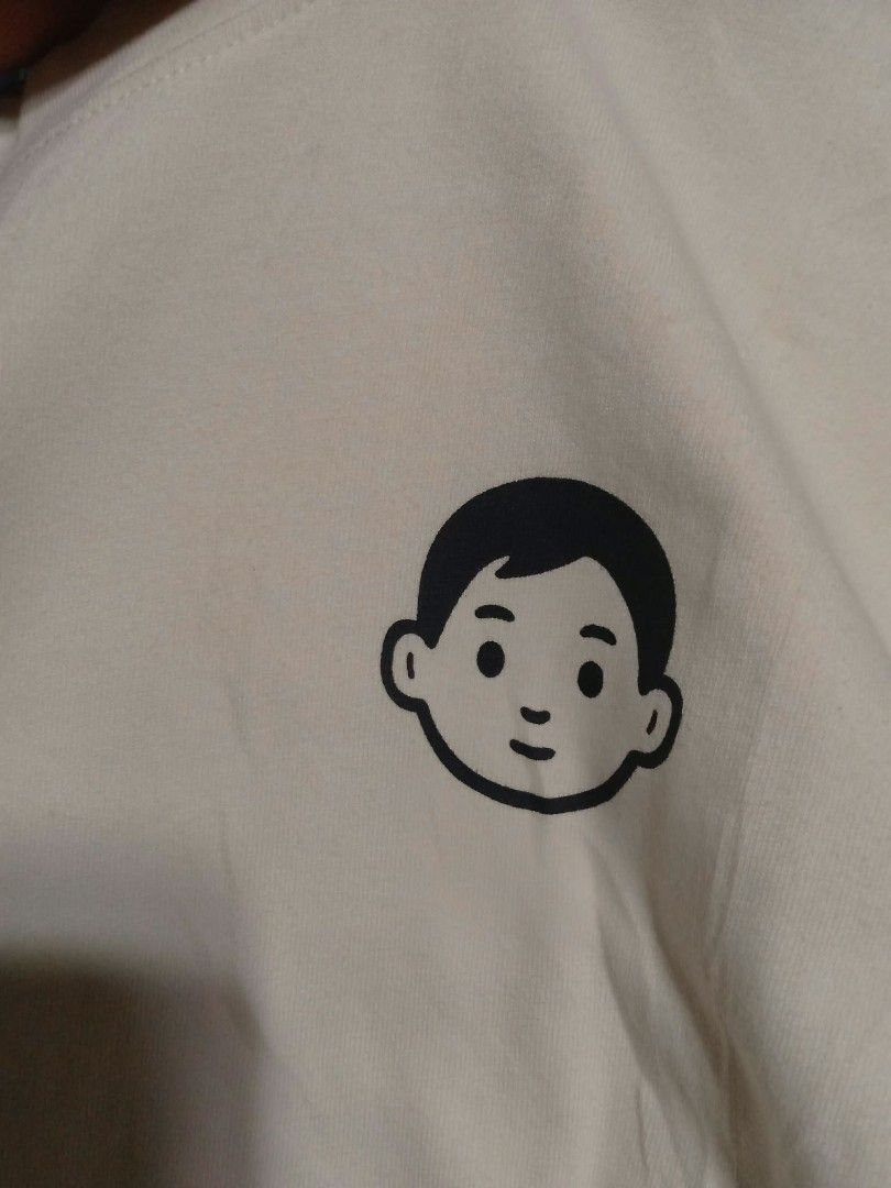 New Balance Graphic T-Shirt (Category: Tshirts & Polo Shirts ) located in Valenzuela. Submitted by AnahThrift (Listing ID 1469334144, Image 3). Description: - Brand: New Balance - Color: Off-white - Size: M (Measures approx. 19.5" x 25.25") - Design: Small boy character graphic print on front - Origin: Made in China - Style: Casual streetwear, easy to pair with jeans or shorts.