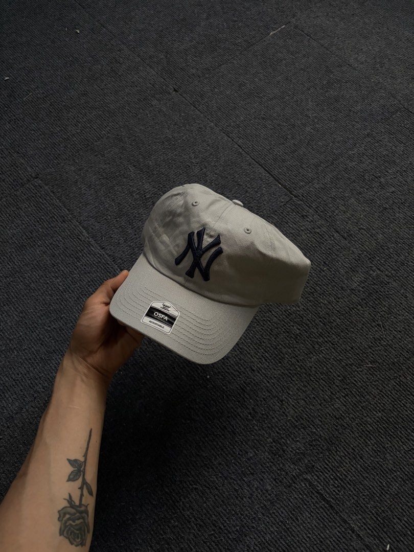 New York Yankees Grey Adjustable Baseball Cap (Category: Caps & Hats) located in Manila. Submitted by toys_hats005 (Listing ID 1469183793, Image 1). Description: - Authentic New York Yankees baseball cap in classic grey - Contrast navy blue embroidered NY logo on the front - Adjustable strapback closure with a sleek metal buckle - Structured front panels with a curved brim - Brand new with genuine merchandise tags still attached - Clean interior 
