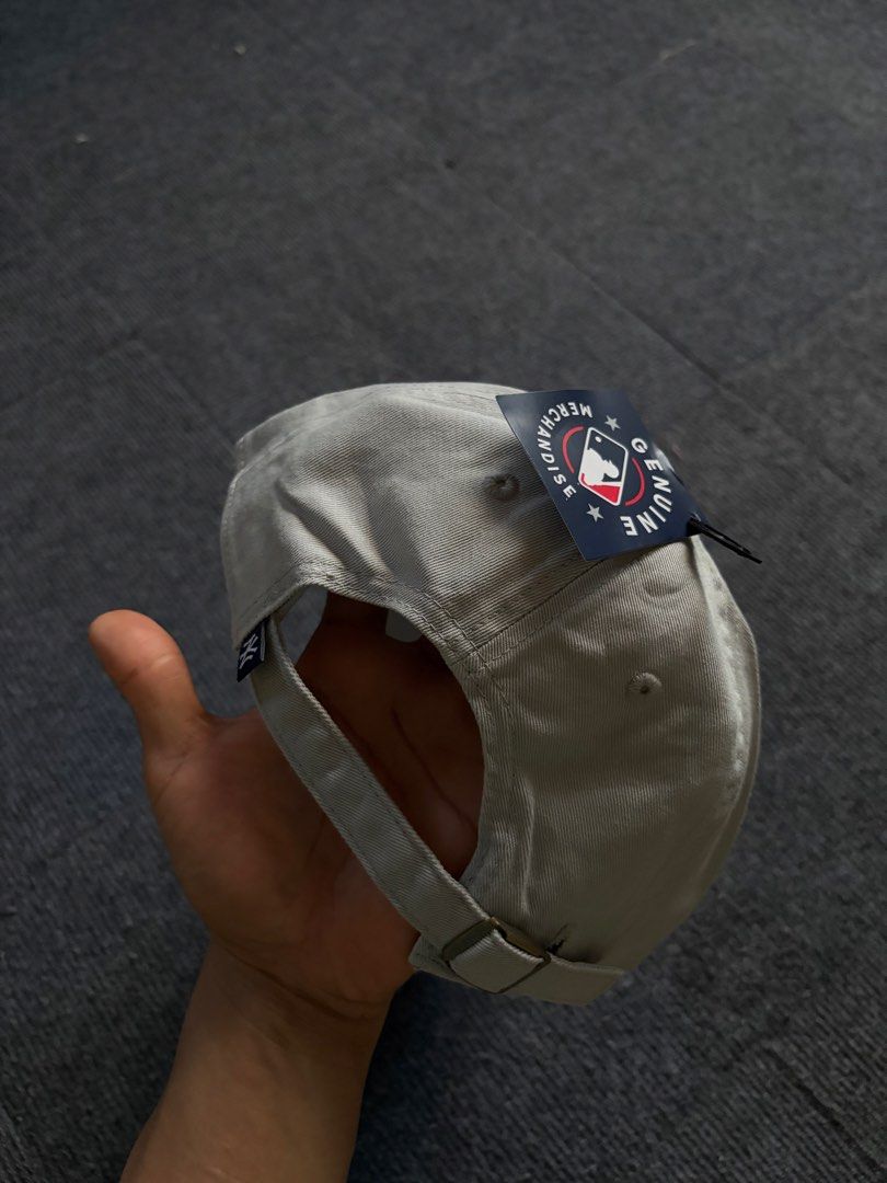 New York Yankees Grey Adjustable Baseball Cap (Category: Caps & Hats) located in Manila. Submitted by toys_hats005 (Listing ID 1469183793, Image 2). Description: - Authentic New York Yankees baseball cap in classic grey - Contrast navy blue embroidered NY logo on the front - Adjustable strapback closure with a sleek metal buckle - Structured front panels with a curved brim - Brand new with genuine merchandise tags still attached - Clean interior 