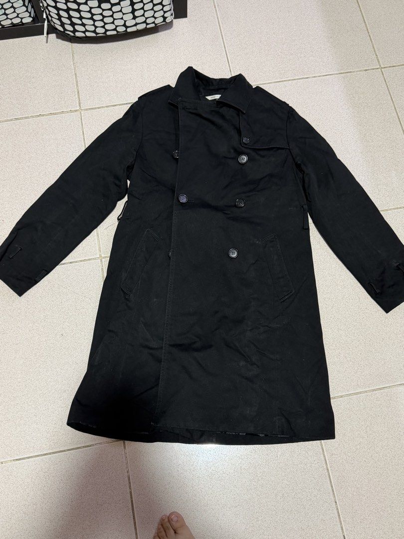 Nice Claup Black Double Breasted Trench Coat (Category: Coats, Jackets and Outerwear) located in Quezon City. Submitted by wonderrv18 (Listing ID 1469206638, Image 1). Description: - Brand: Nice Claup - Style: Black double-breasted trench coat with a clean silhouette - Details: Collared neckline, button-up front, two front slant pockets - Sleeves: Long sleeves with adjustable strap details on cuffs - Length: Classic mid-length outerwear - Conditi