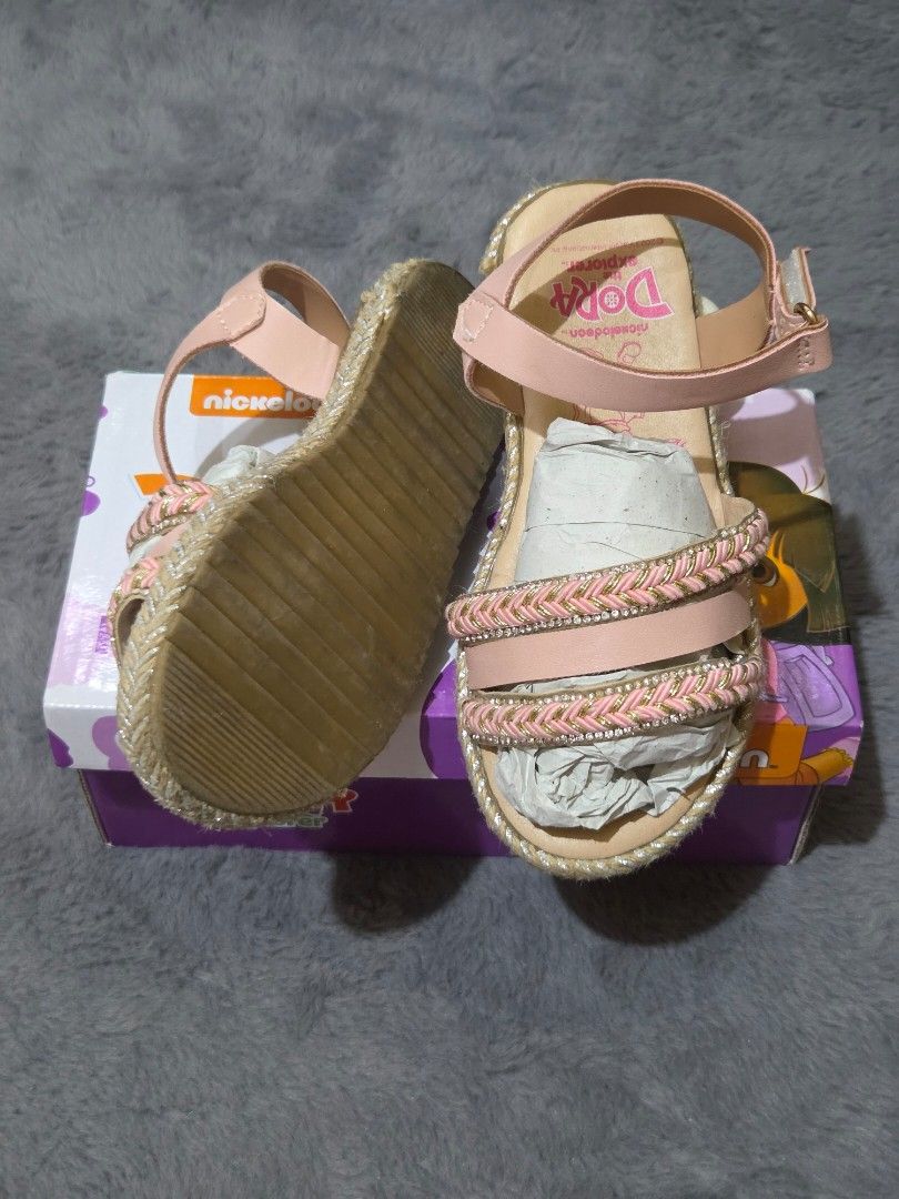 Nickelodeon Dora the Explorer Pink Sandals (Category: Babies & Kids Fashion) located in Bulacan. Submitted by gtrvddg (Listing ID 1469226201, Image 2). Description: - Brand: Nickelodeon Dora the Explorer - Color: Pink - Design: Braided strap details with ankle strap buckle closure - Soles: Flat soles with textured bottom grip for safety - Packaging: Includes original Nickelodeon branded box - Condition: Like new / Excellent quality.